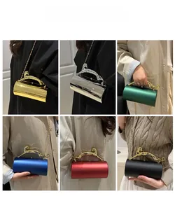 Macro details of acrylic cylinder clutch bags featuring leopard shaped metal handles