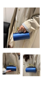 Detailed view of cylindrical blue evening bag featuring a golden leopard-shaped handle