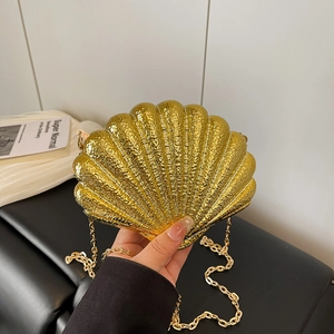 Elegant gold shell-shaped evening clutch bag with metallic radiance and chain strap