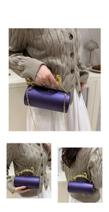 Macro detail of purple cylinder evening bag with gold leopard handle and chain strap