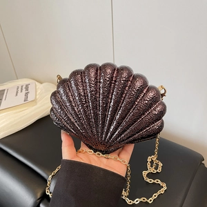 Shell shaped evening clutch bag in dark bronze metallic finish with gold chain strap