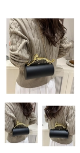 Cylindrical evening bag with a gold leopard handle and chain strap on a model