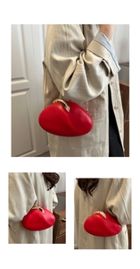 Detail of red pebble-shaped PU clutch with elegant gold metal clasp and thin chain strap