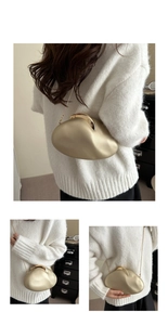 Detail of elegant gold geometric clutch bag with metallic luster and chain strap