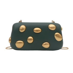 Detail view of dark green evening bag with luxury gold pebble-shaped metal accents