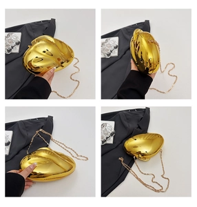 Detail view of gold liquid-shaped evening clutch with reflective finish and chain strap