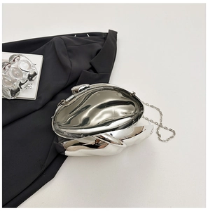 Macro view of silver metallic dinner clutch with reflective mirror finish and chain