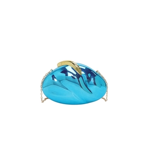 Detail of blue mirror acrylic clutch bag with golden semi-moon handle and chain strap