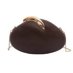 Detail of chocolate brown pebble clutch with gold clasp and elegant snake chain