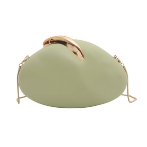 Close-up of pebble-shaped green evening bag with gold handle and chain strap detail