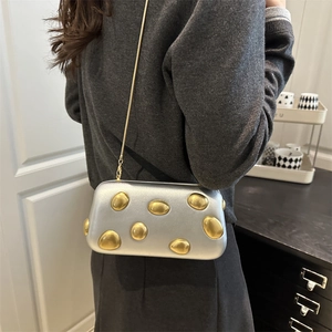 Artistic silver hard shell evening clutch with gold polka dots and chain strap