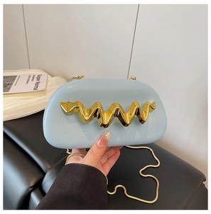 Detail of light blue evening bag featuring gold wavy metal buckle and chain strap