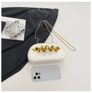 Detailed size comparison of a minimalist white evening bag with golden metal trim and chain