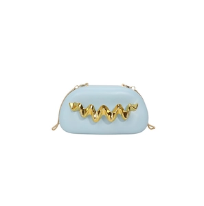 Detail of light blue box evening bag with wave gold metal trim and chain strap