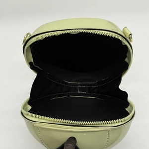Lime green apple-shaped crossbody bag in glossy patent leather with gold zippers
