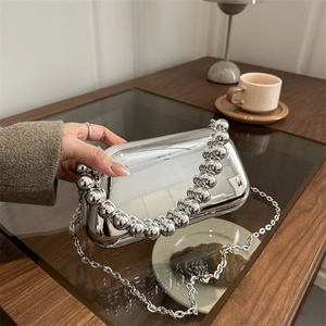 Silver metallic acrylic clutch bag with beaded handle and chain strap for evening party