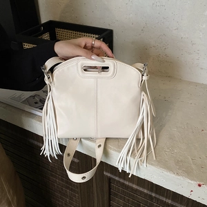 Creamy white PU leather tote bag with stylish long side tassels and wide shoulder strap
