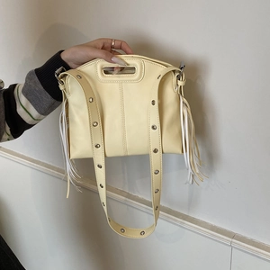 Fashionable cream yellow PU tote bag with decorative tassels and eyelet wide strap