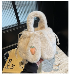 Close-up of fluffy cream bucket bag featuring cute carrot embroidery and drawstring closure