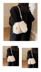Detailed view of white plush bucket bag with cute carrot embroidery and adjustable strap