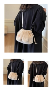 Detail of plush rabbit bucket bag showing faux fur texture and carrot embroidery detail