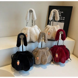 Detail view of five colors of plush bunny bucket bags with decorative ears and carrot accents