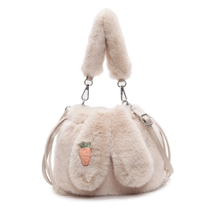 Detailed shot of plush bucket bag featuring soft faux fur texture and carrot embroidery