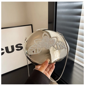 Close-up of a silver metallic evening clutch bag with sparkling rhinestone flower motifs