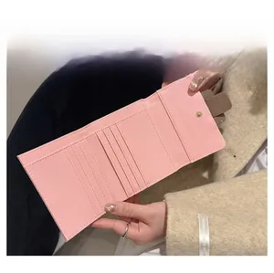 Detailed interior of a pink trifold wallet showing card slots and large bill compartment