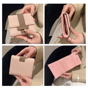 Detail view of pink trifold wallet with woven texture, multiple card slots and compact design