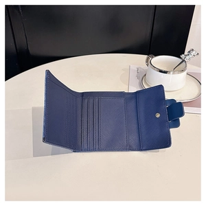Detail of navy blue trifold wallet showing multi-card slots and crossgrain texture