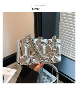 Macro view of silver wave texture acrylic clutch bag with shiny mirror metallic finish