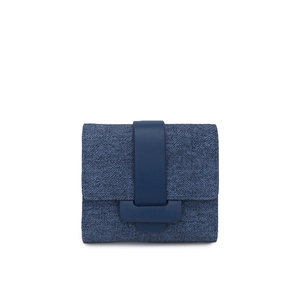Close-up of small navy blue denim wallet featuring a leather strap buckle closure