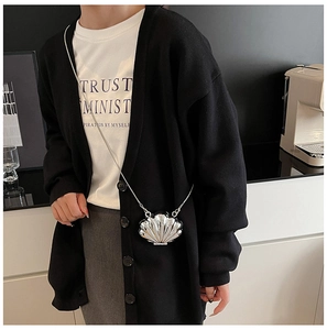 Mini shell-shaped crossbody bag in metallic silver finish with a fine metal chain strap