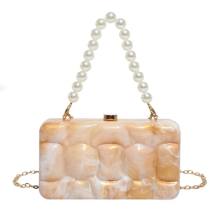 Acrylic handbag with orange marble texture, pearl top handle and gold chain strap