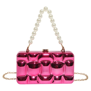 Detail of rose red metallic evening clutch with 3D grid texture and pearl handle