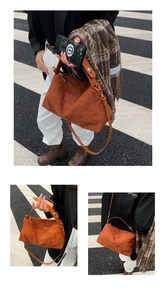 Detailed macro view of the brown suede crossbody bag showing the quilted diamond pattern texture