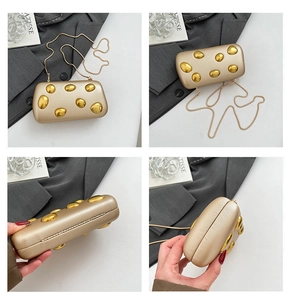 Detail view of champagne gold evening bag with 3D pebble accents and detachable chain