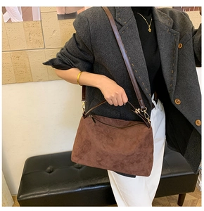 Brown suede tote bag styled with gray blazer and white pants for a chic look