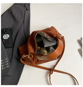 Macro detail of dark brown suede woven bag interior showing large capacity for cosmetics