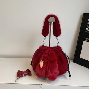 Furry burgundy bucket bag with plush rabbit ears, drawstring closure and carrot charm