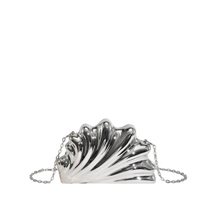 Detailed view of silver shell-shaped acrylic evening bag with metallic finish and chain