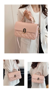 Detail of pink quilted handbag with gold-tone hardware lock and elegant crossbody strap