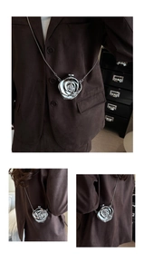 Close-up of silver metallic 3D flower mini bag with elegant crossbody chain detail