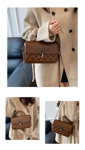 Brown quilted crossbody bag detail showing gold-tone lock and adjustable leather strap