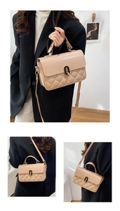 Close-up of beige quilted crossbody bag with gold-tone lock and detachable strap