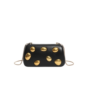 Detail of black matte PU leather clutch with golden pebble stones and snake chain