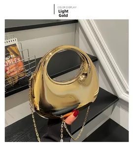Detail view of light gold mirror finish acrylic bag with large round handle and chain