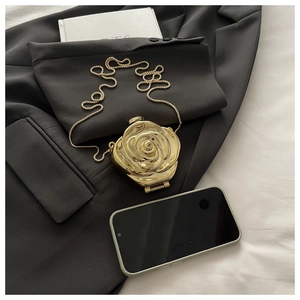 Detailed close-up of golden rose-shaped evening bag with a metallic finish and chain strap