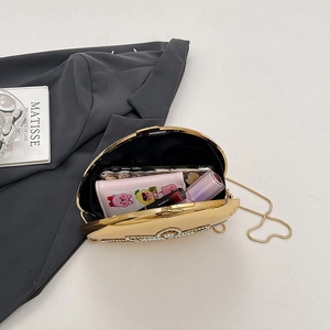 Elegant champagne gold oval clutch bag with pearl and rhinestone trim and gold chain strap